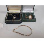 A 9ct pearl pendant and chain, a 9ct garnet pendant and chain, a cameo pendant with mount and