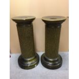 A pair of Burmantofts green glazed pedestals, each with reeded columns and spreading circular tops