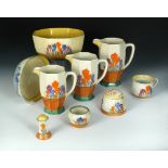 A collection of Clarice Cliff Crocus pattern wares, comprising graduated set of three jugs, an