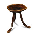 Liberty & Co., a Thebes stool, the decorated dished seat raised on three shaped legs 44cm (17in)