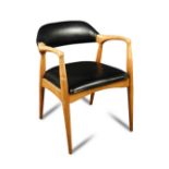 Ben Chairs of Stowe, a 1960's elbow chair, with shaped back and black vinyl upholstery, original