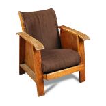 A 1930's oak framed easy chair, with loose cushion seat and upholstered back, one side with book