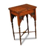Attributed to Liberty & Co., a Moorish work table, the hinged two-piece top opening to reveal a