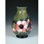 A Moorcroft Anemone pattern vase, circa 1950, the baluster form decorated to a green ground, painted