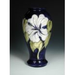 A large Moorcroft Hibiscus pattern vase, the inverted baluster form decorated in pale blue on a deep
