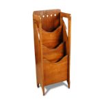 A Glasgow style mahogany magazine rack by Finnigans, the tiered rack with shaped front boxwood