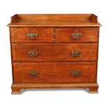 An Arts & Crafts walnut chest of drawers, the three quarter galleried top above two short and two