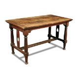 An Arts & Crafts oak library table, the rectangular top on turned legs and central uprights with