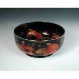A Moorcroft Pomegranate pattern fruit bowl, of circular form decorated with a series of both open