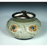 A Macintyre Moorcroft Poppy pattern tobacco jar and cover, of squat bulbous form, the cover with