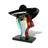§ Alessandro Barbaro for Murano, a Picasso style glass head, modelled wearing a wide brimmed hat,