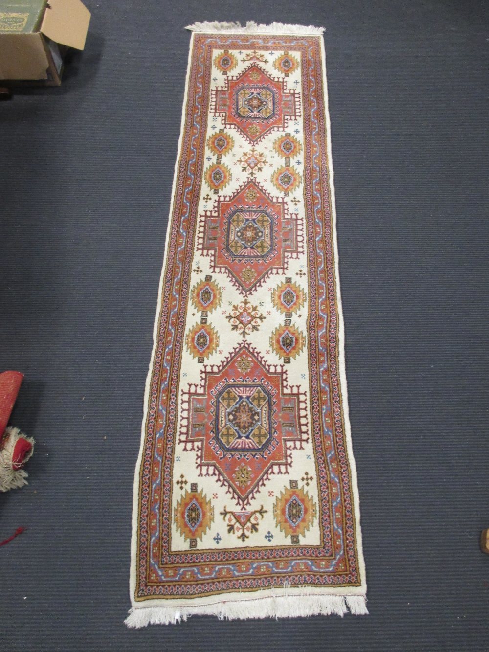 A near pair of ivory ground runners largest 252 x 65cm (2)