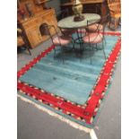 A modern blue and red ground rug, 251 x 170cm
