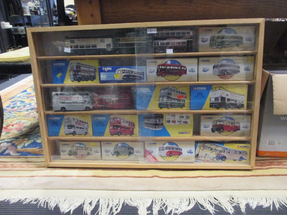 Corgi Classics. 15 buses and coaches, all with boxes, together with a wall display cabinet