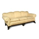 A large George II style sofa, 20th century, with shaped back and loose cushions, upholstered in a