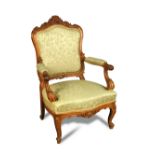 A pair of French carved walnut framed fauteuil, 20th century, upholstered in a pale green woven