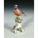 An 18th century Derby patch mark figure of a bird, naturalistically coloured and perched on a floral