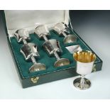 A set of six silver wine goblets, by C J Vander, London 1974, cased each having a plain bowl of