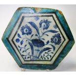 A 15th century Islamic Syrian Mamluk tile, of hexagonal form, the centre painted with flowers,