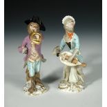 Two 19th century Meissen monkey band figures, after J. J. Kaendler, one holding a hurdy-gurdy whilst