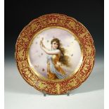 A 19th century Vienna plate, painted within gilt claret rim band with a golden robed beauty