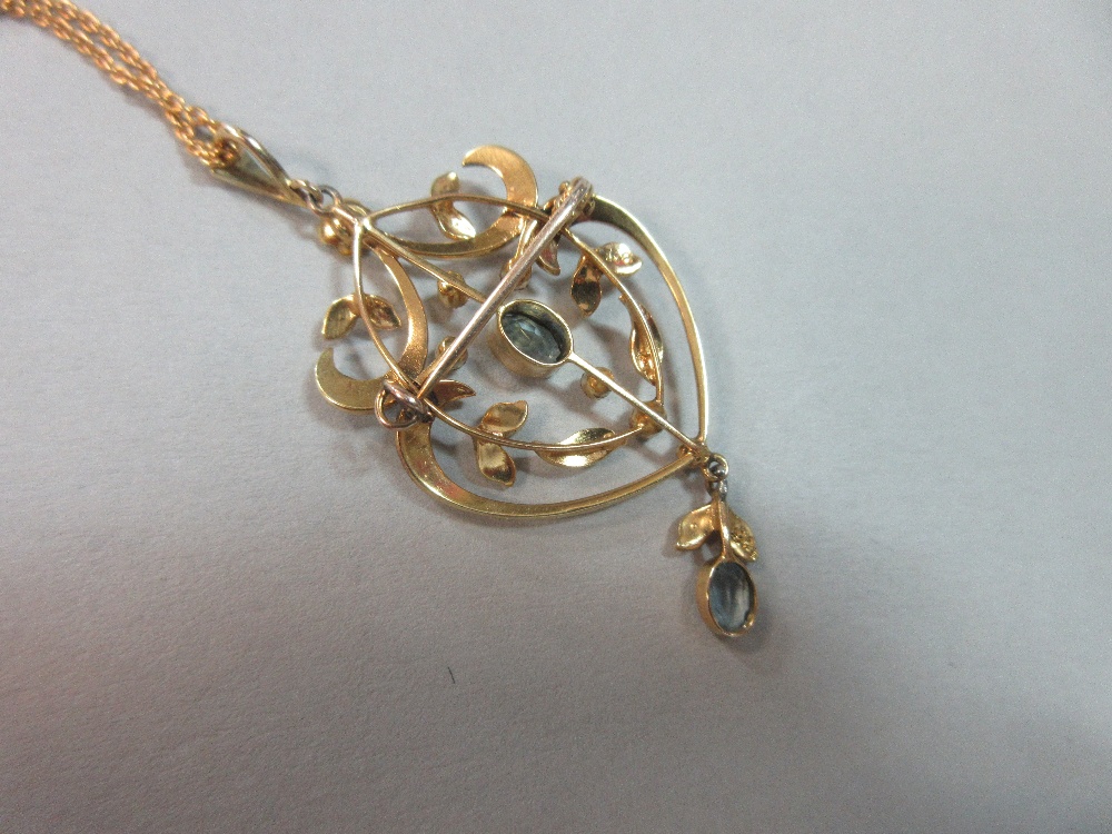 An Edwardian aquamarine and seed pearl pendant / brooch on an 18ct gold chain, of light, pierced and - Image 4 of 4