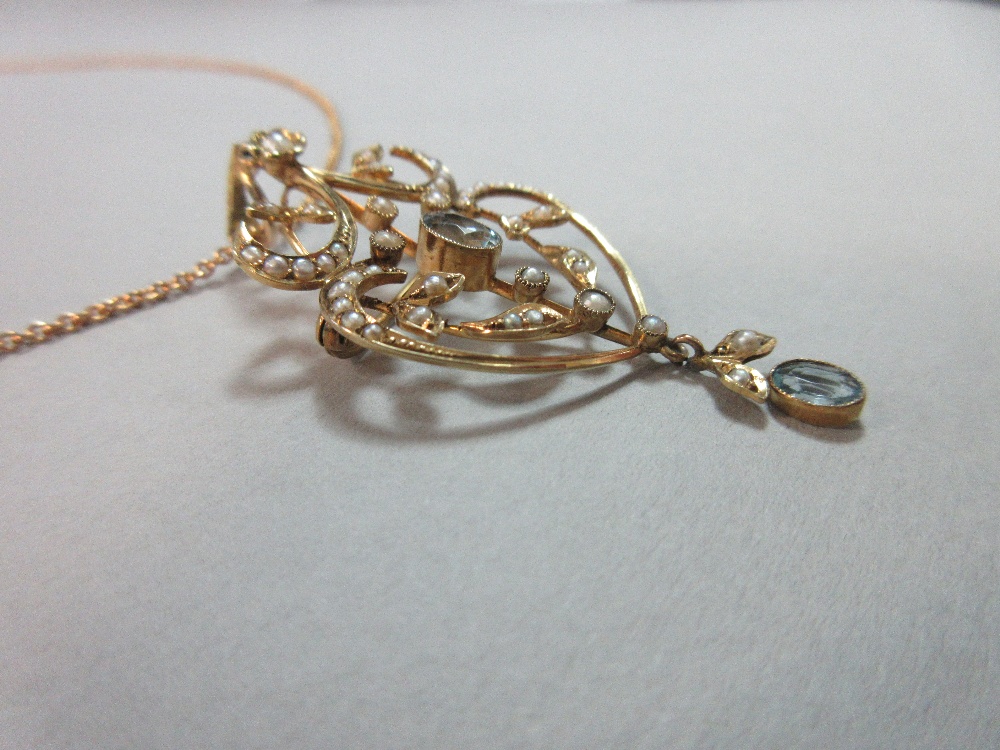 An Edwardian aquamarine and seed pearl pendant / brooch on an 18ct gold chain, of light, pierced and - Image 3 of 4