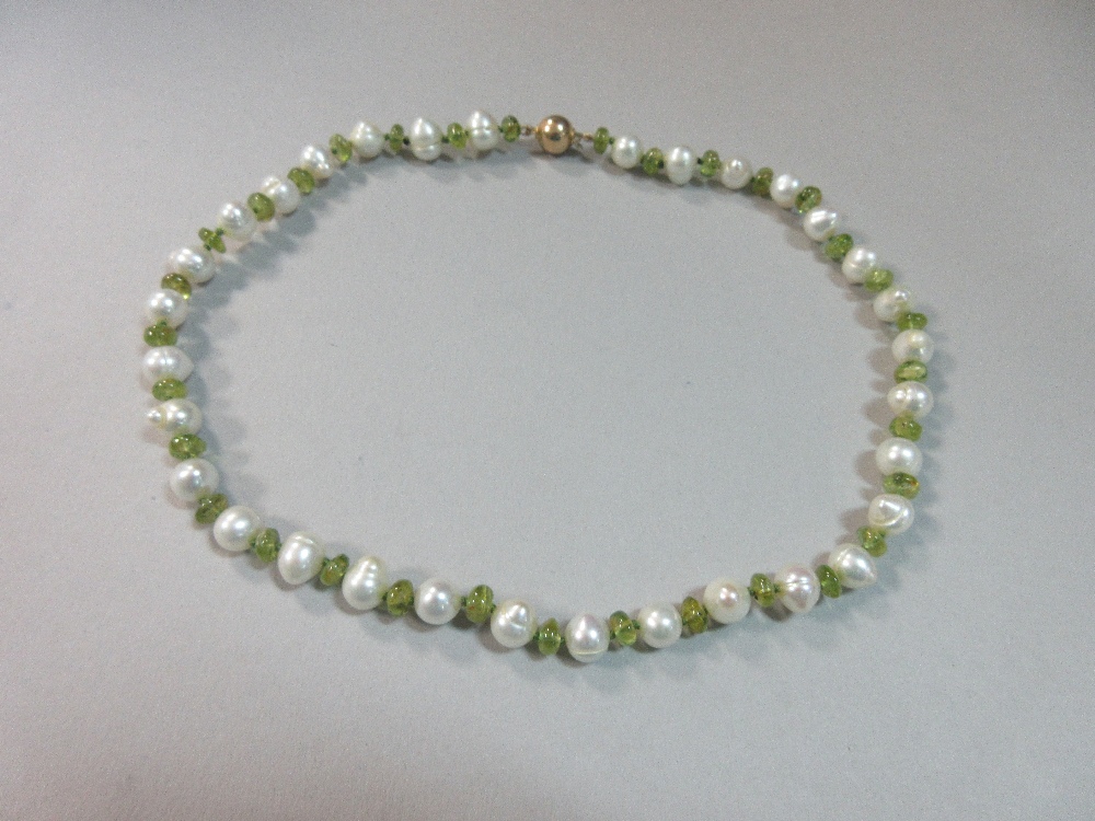 A peridot and pearl necklace, with alternating polished bouton peridots and 8mm freshwater pearls,