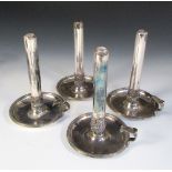 A set of four Old Sheffield plate chambersticks, unmarked, each with a circular tray base with