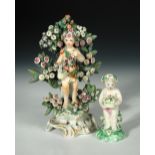An 18th century Bow porcelain model of a putto, standing in front of boccage, on pierced scroll