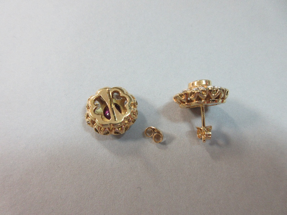 A pair of rhodolite and diamond flowerhead earstuds, each round cut rhodolite garnet collet set in a - Image 4 of 7