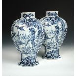 A pair of Delft blue and white vases, of slender shouldered baluster form, each painted with an