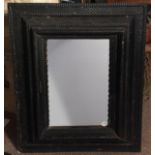 A 17th century Dutch ebonised frame, with gadrooning and basket weave carved decoration,