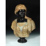 A specimen marble portrait bust of a Nubian, mounted to a socle and spreading circular foot 68cm (