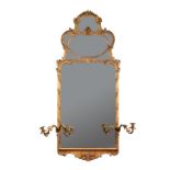 A gilt framed pier glass in the Rococo manner,19th century, with an elaborate cresting of six