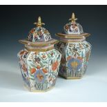 A pair of 19th century Mason's imari hexagonal vases and covers, decorated in the typical palette of