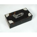 A late Victorian table cigarette box, the rectangular body veneered in tortoiseshell, the cover with