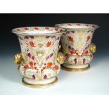 A rare pair of Regency Mason's porcelainous campana shaped wine coolers, each with two gilt rose