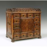 A 19th century Dutch marquetry inlaid table top cabinet, the central cupboard surrounded by small
