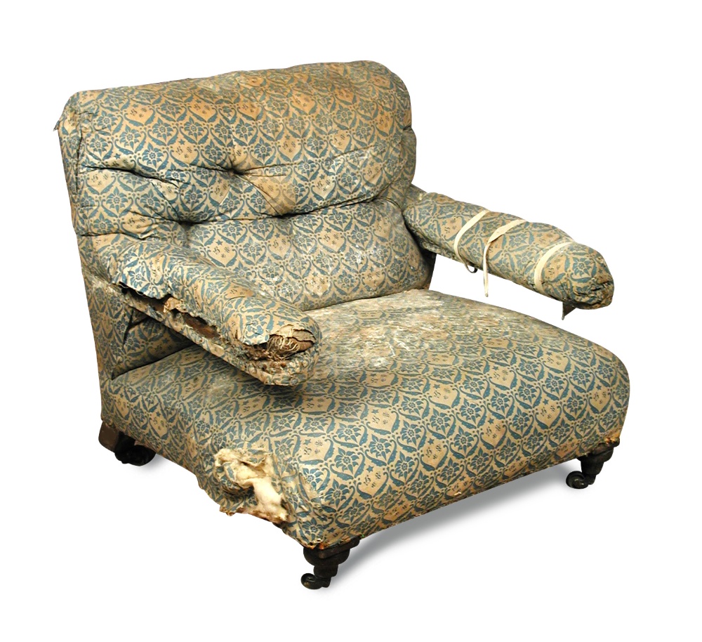 A Howard armchair, late 19th century, upholstered in original printed fabric, on turned front