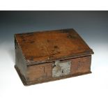 A 17th century oak bible box with chip carved lectern, the front carved with the initials TB 17 x 33