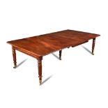 A Regency mahogany extending dining table by Alder of Cheltenham, with a rule moulded edge, brass