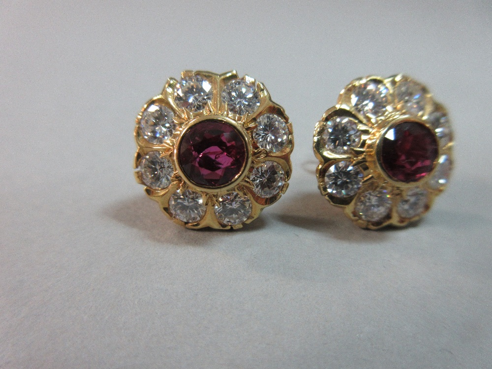 A pair of rhodolite and diamond flowerhead earstuds, each round cut rhodolite garnet collet set in a - Image 6 of 7