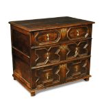 A James II small oak chest, of three long drawers with geometric moulded panels and brass drop