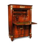 A French Empire mahogany secretaire a abattant, with an inset marble top and applied gilt metal