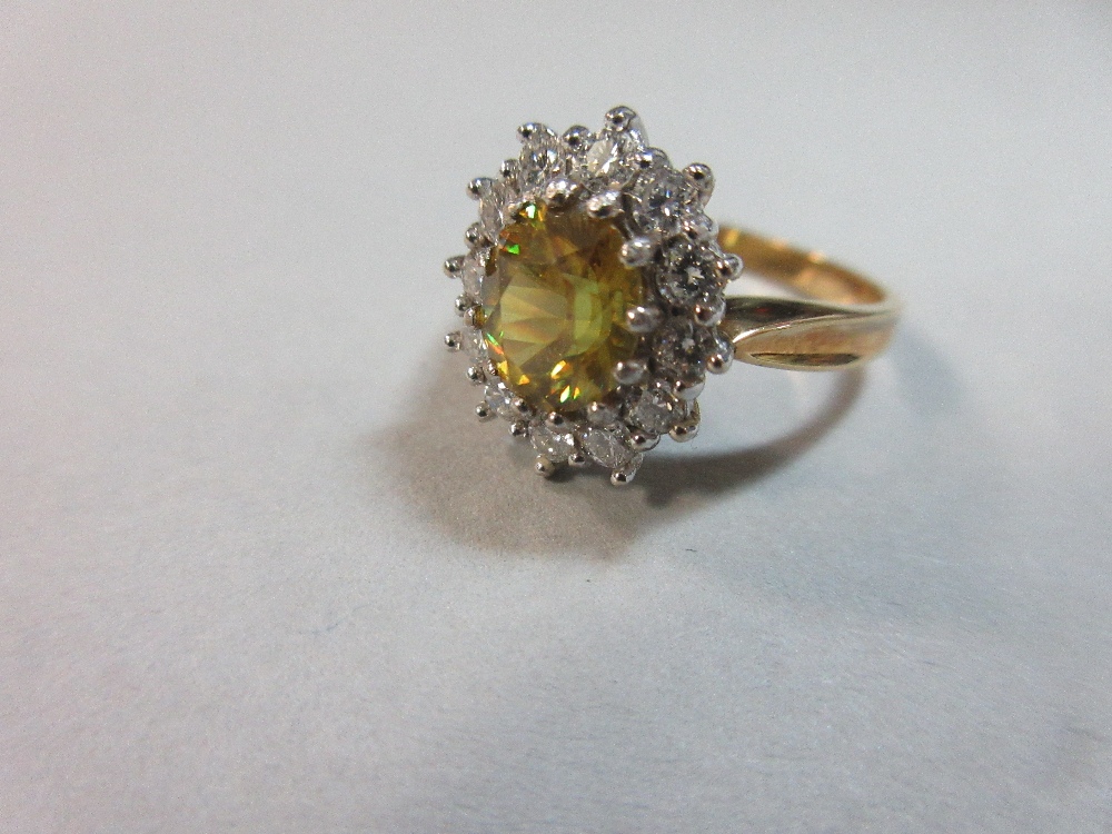 A golden sphene and diamond cluster ring set in 18ct gold, the oval cut sphene of intense slightly - Image 3 of 6