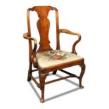 A George I walnut dining chair, with shepherd crook arms, drop in seat, on shell carved cabriole