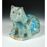A Raqqa pottery model of a seated cat, Syria, 12th /13th cenury, decorated in black on a turquoise