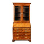 A George I walnut bureau bookcase, feather banded border inlaid decoration, with glazed doors and