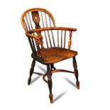 A yew wood Windsor armchair, late 18th century, with elm seat, on turned supports, united by a